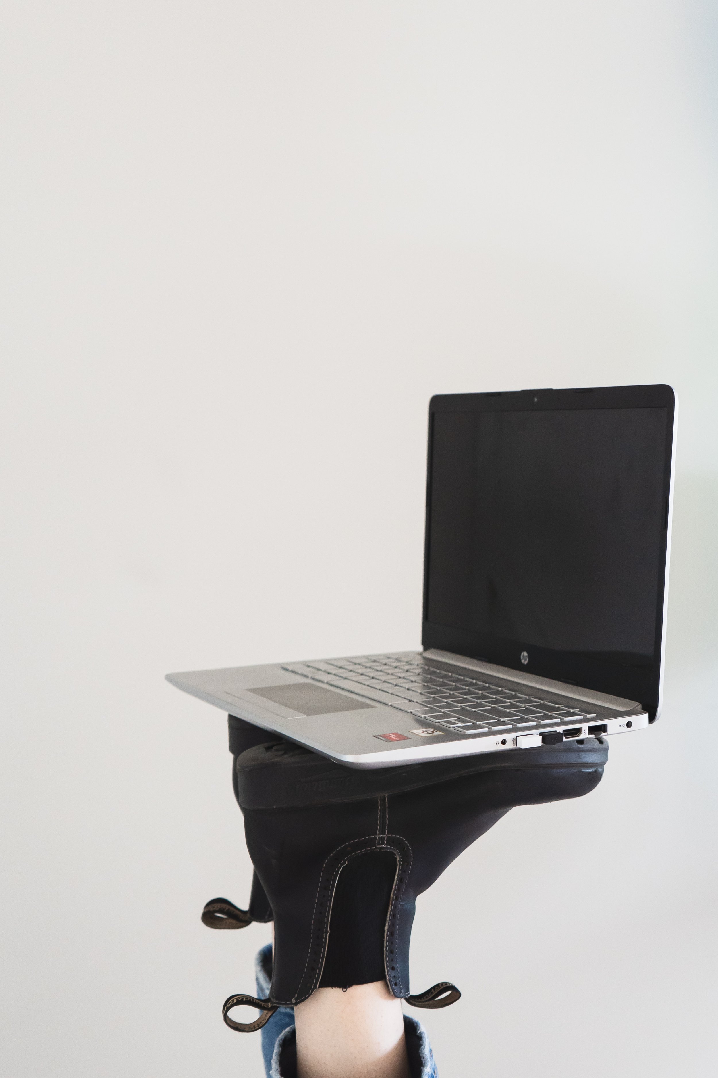 A women's health coach's laptop sitting on her boots in Ayr Ontario.