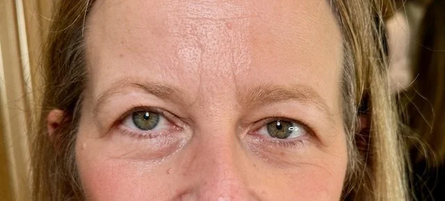 Close-up of a woman's eyes and forehead.