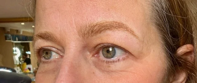 Close-up of a person's face focusing on their eyes and eyebrows.