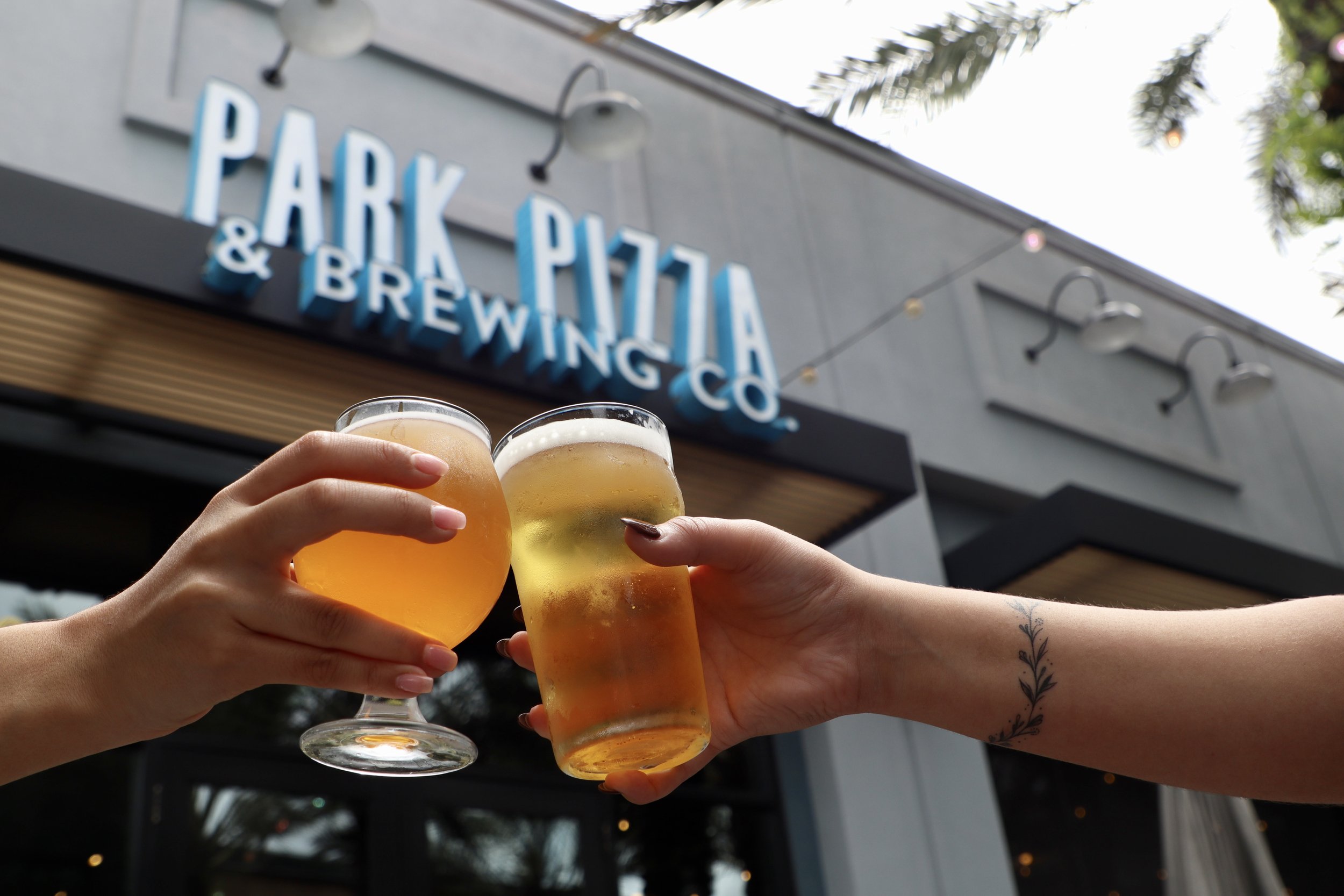 Beer cheers outside of Park Pizza & Brewing Co. in Lake Nona