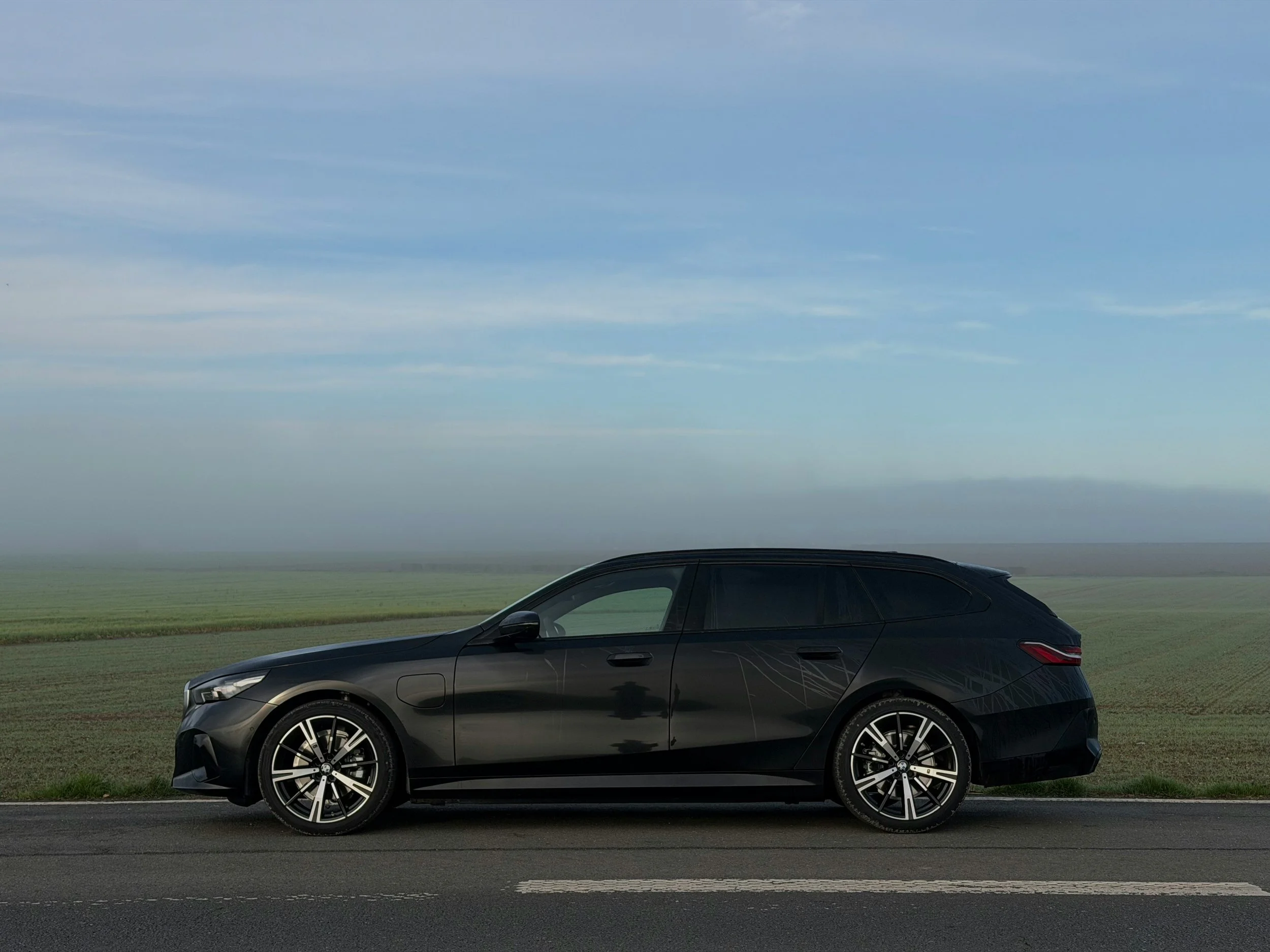 Digital illustration of a green compact car with tinted windows and black tires.