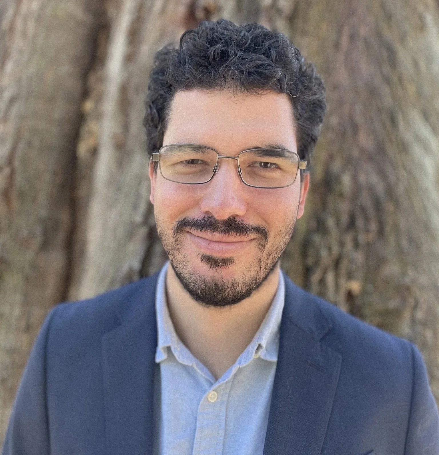 Joseph Brooks, RMHCI therapist in Florida, professional headshot outdoors in front of a tree.