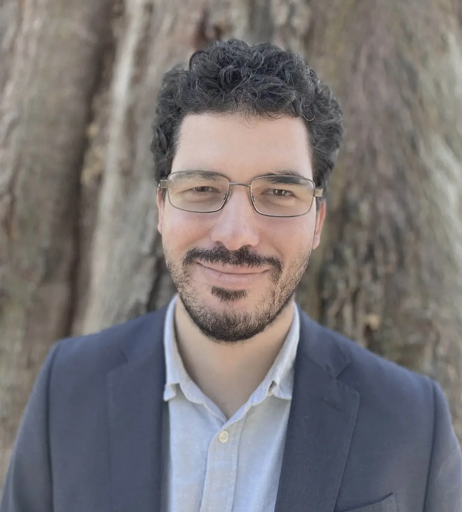 Joseph Brooks, RMHCI therapist in Florida, professional headshot outdoors in front of a tree.