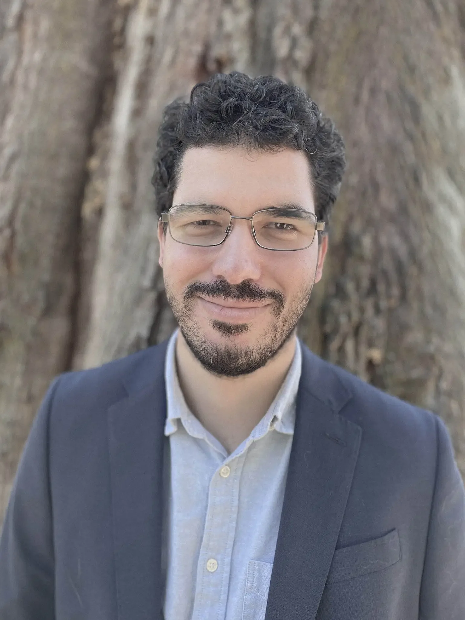 Joseph Brooks, RMHCI therapist in Florida, professional headshot outdoors in front of a tree.