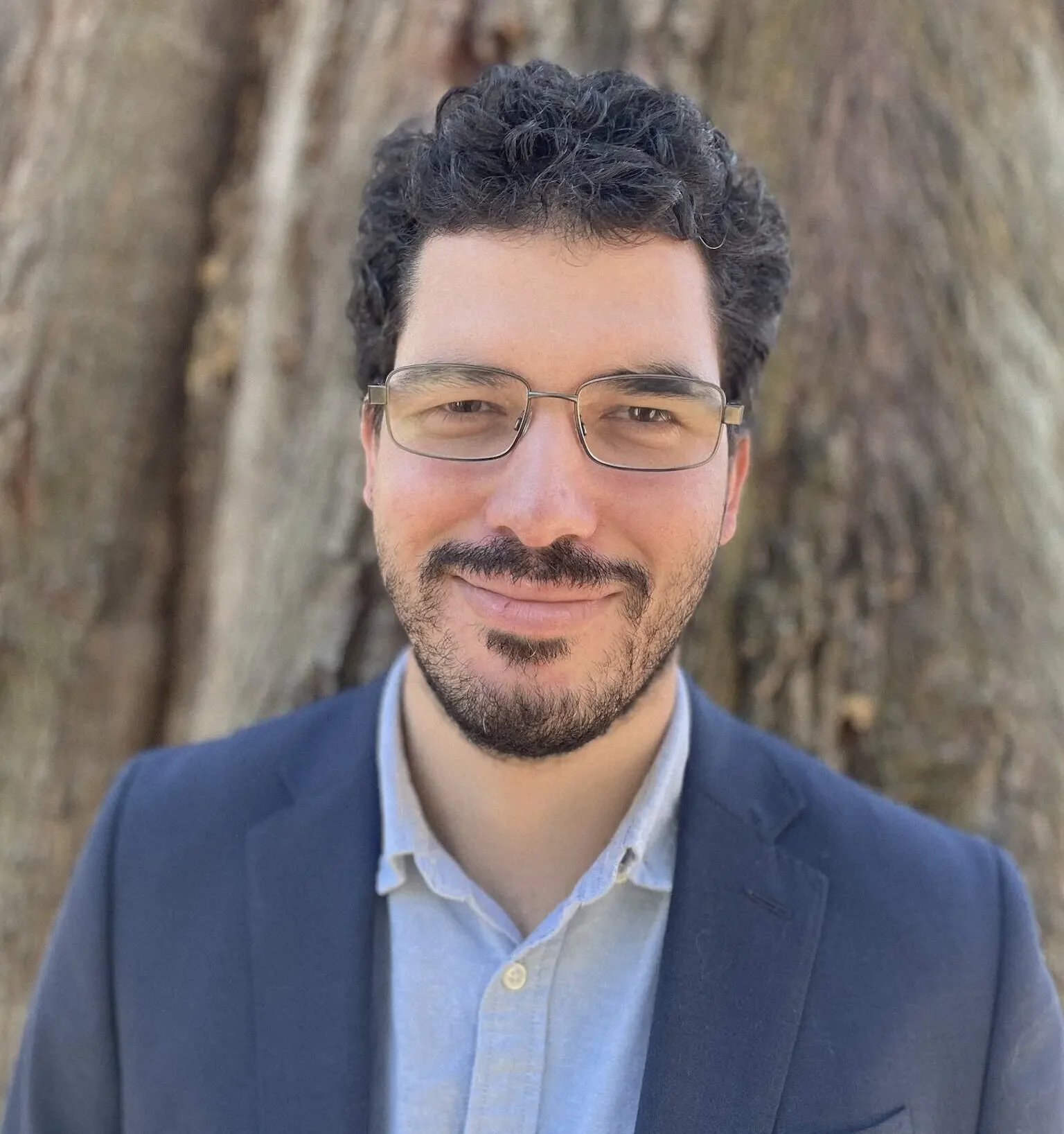 Joseph Brooks, RMHCI therapist in Florida, professional headshot outdoors in front of a tree.
