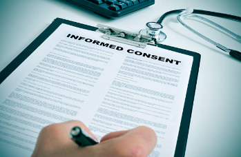 Person signing an informed consent form for a clinical research study, representing participant rights, informed decision-making, and ethical research practices.