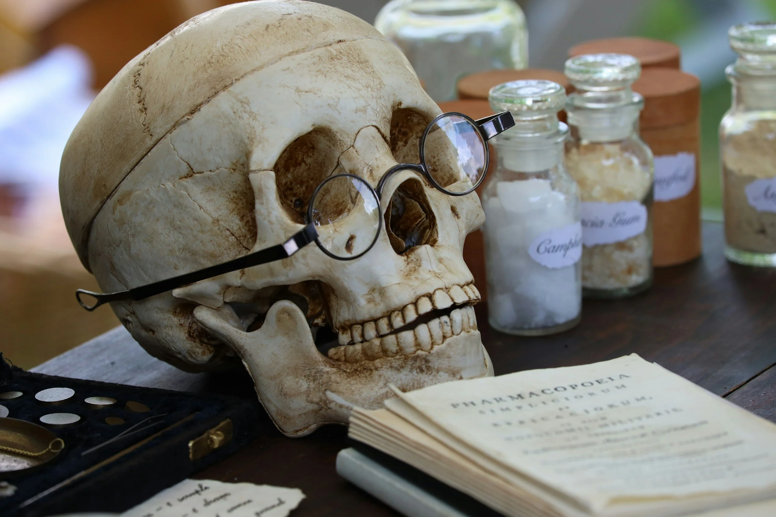 Historic medical school wearing round glasses beside research books and laboratory jars, symbolizing early medical research and the origins of informed consent ethics.