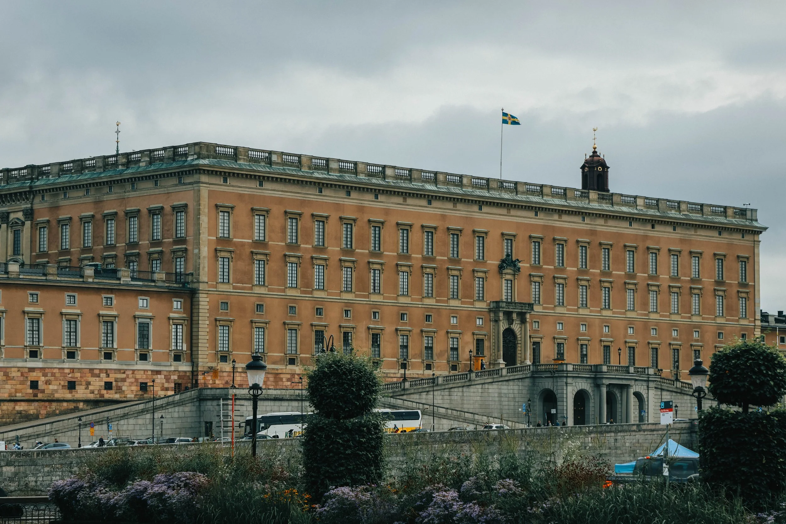 Dear reader,
October is coming, and with it, the hush of fallen leaves and the stir of something unseen. The Royal Palace looms over Stockholm like a sentinel of forgotten timeâits windows watching, its silence too deep. Beneath the blood moonâs eer