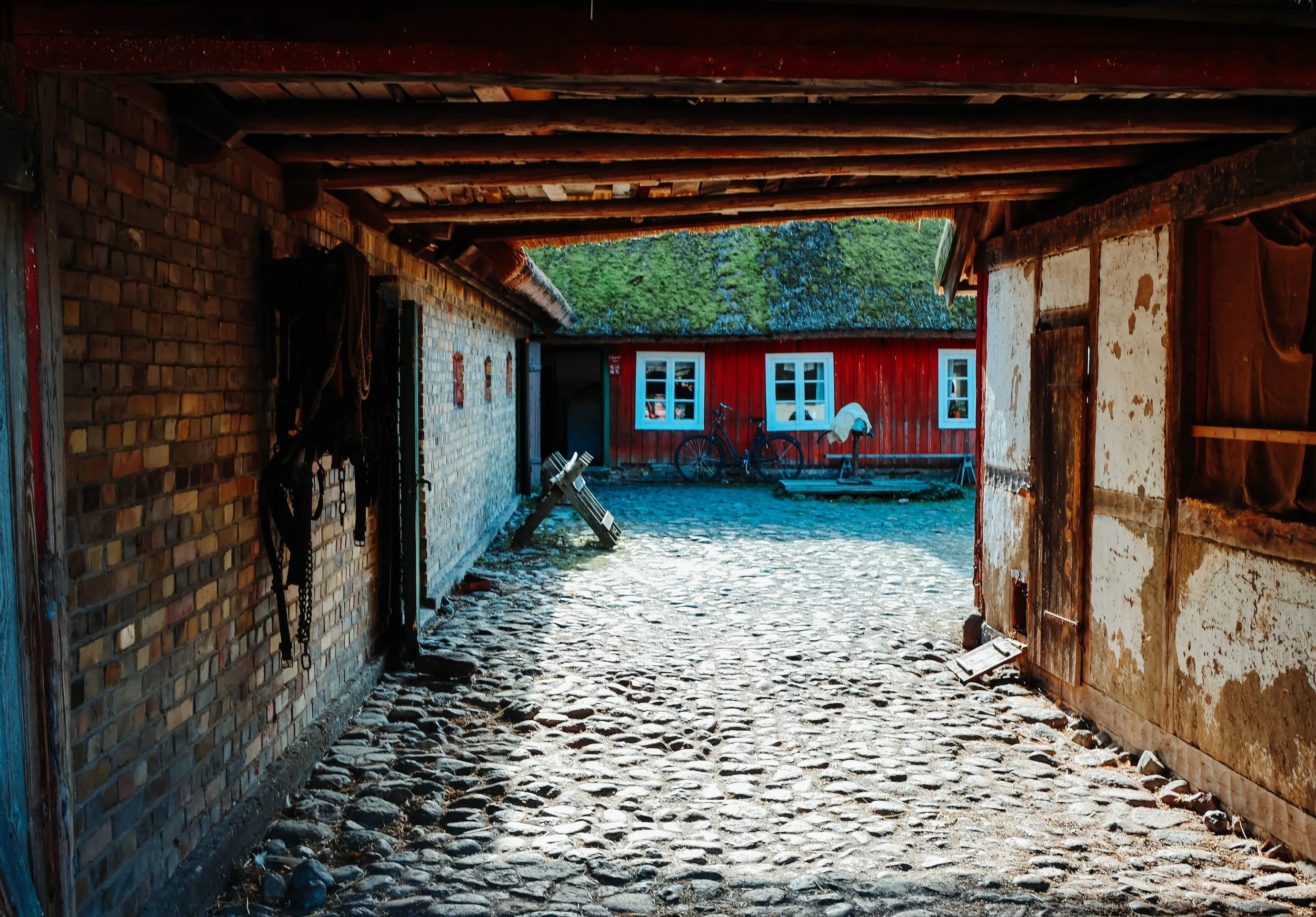 The Courtyard Keeper
Noah ducked beneath the timbered archway, boots tapping softly on the cobblestones still damp from morning mist. The courtyard opened before him like a forgotten pageâsunlight spilling across mossy rooftops, bicycles resting lik