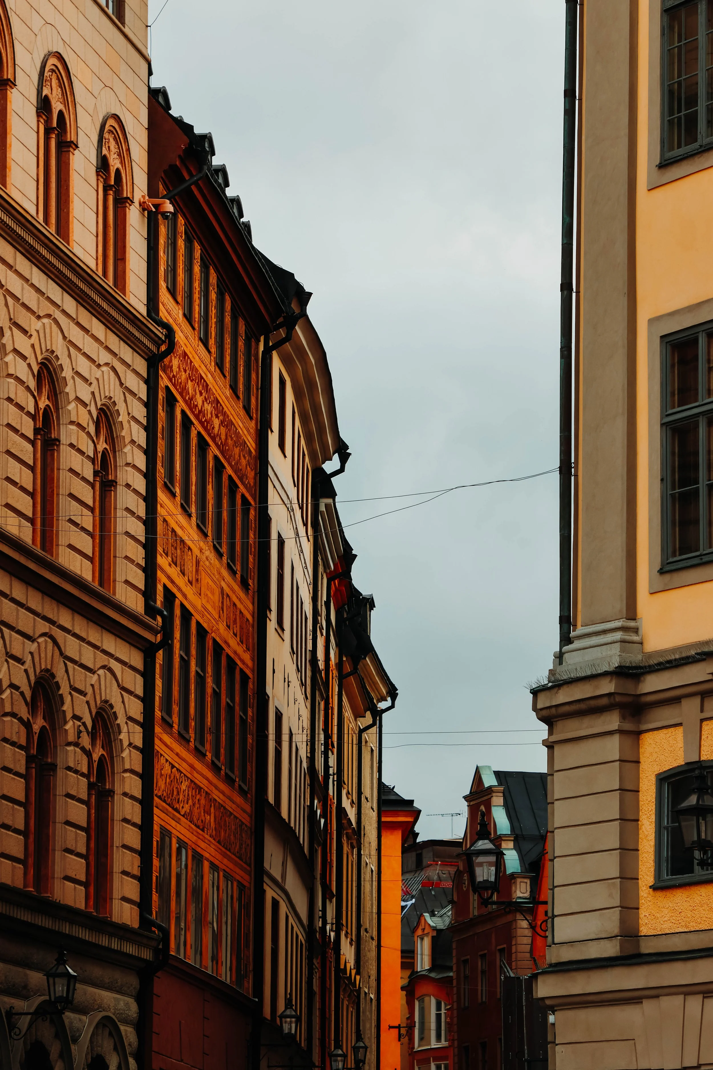 "Donât wander off, dear reader⊠this street has a habit of keeping those who stray. Beneath its warm façades and crooked windows lies a tale older than the bricks themselves. They say the ochre house once belonged to a cartographer who mapped dreams