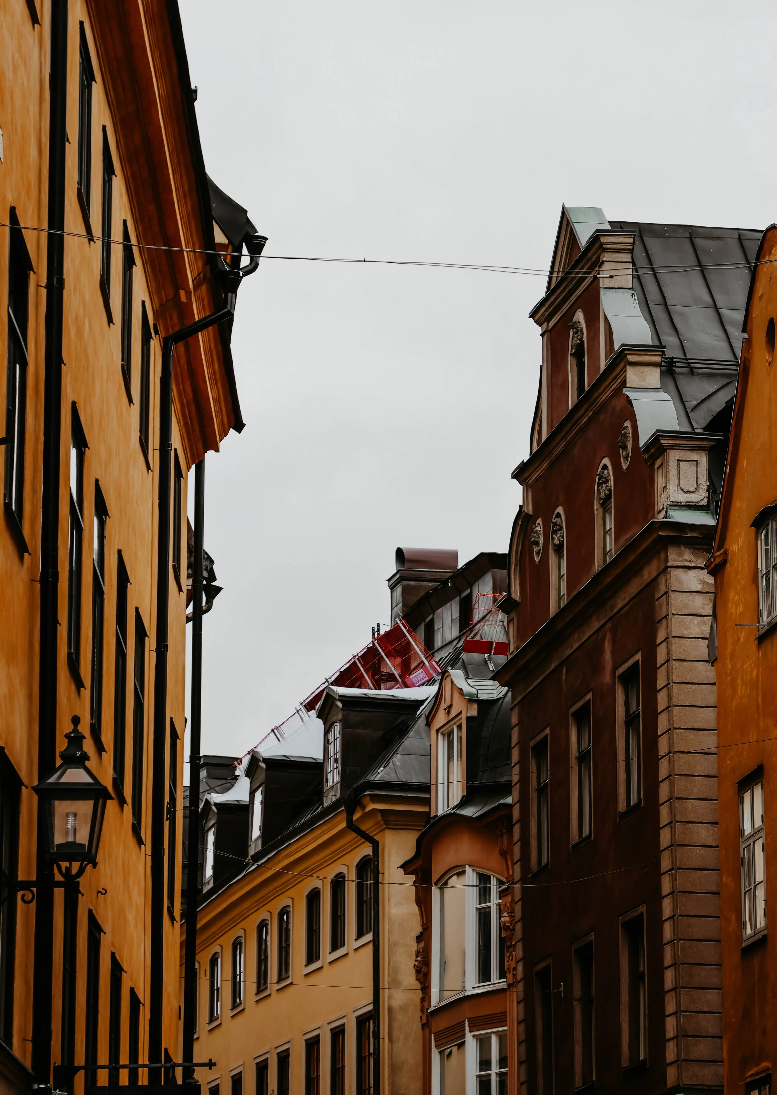 "Youâve returned. Of course you have. This street doesnât forget its visitors â it waits. The buildings lean close not to whisper, but to listen. Locals say the red-roofed house belonged to the SkymningsvĂ€ktare, the Twilight Watcher, who vanished one