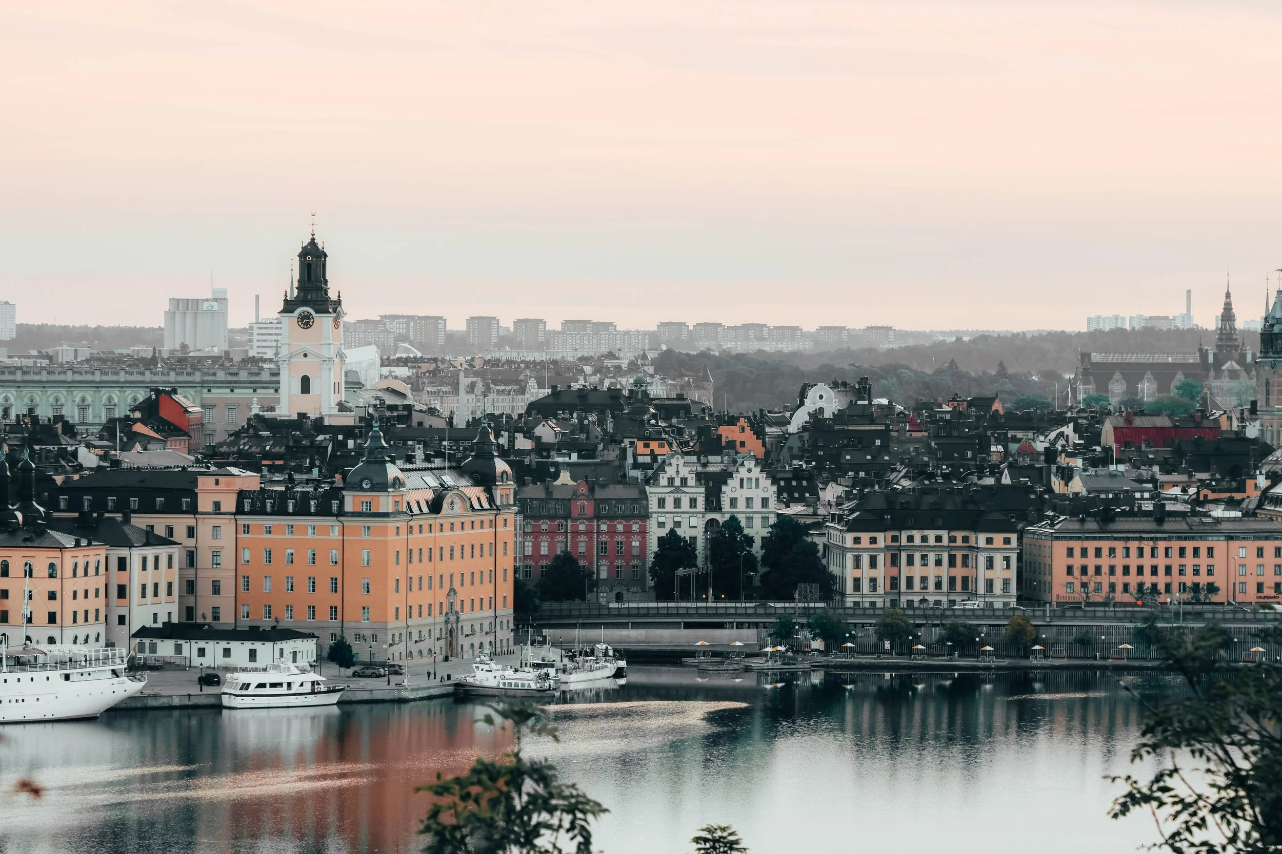 Whispers of autumn in the air.
A quiet Stockholm morning unfoldsâcool, crisp, and serene. The historic facades glow softly in the early light, boats rest gently on the water, and the chill hints at fallâs arrival. Just you, the hush of the city, and