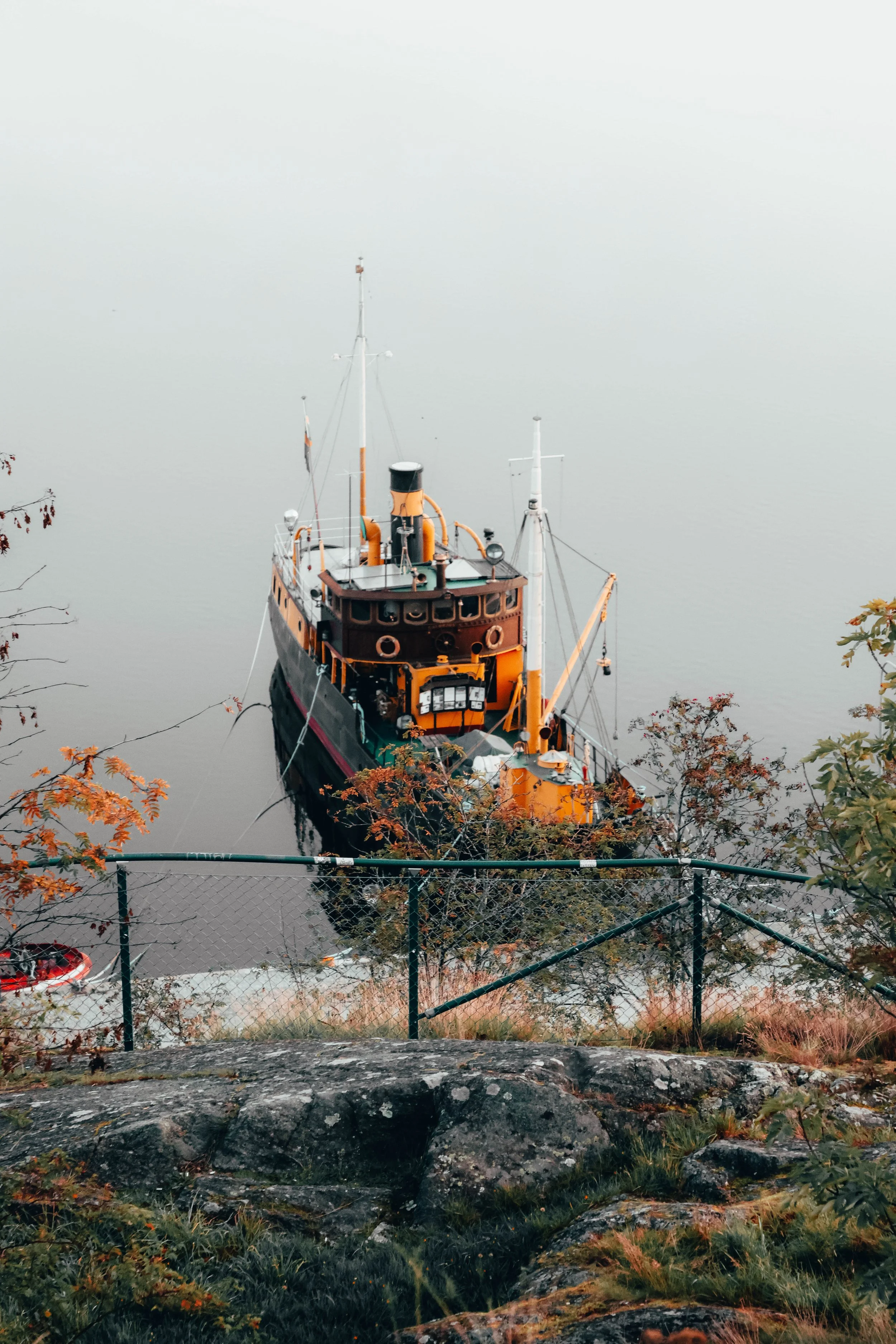 Wrapped in fog and firelight.
As dawn breaks over the chilled autumn harbor, the fishing vessel stands readyâits warm hues glowing against the crisp morning mist. The air bites gently, the water lies still, and the promise of the dayâs first catch l
