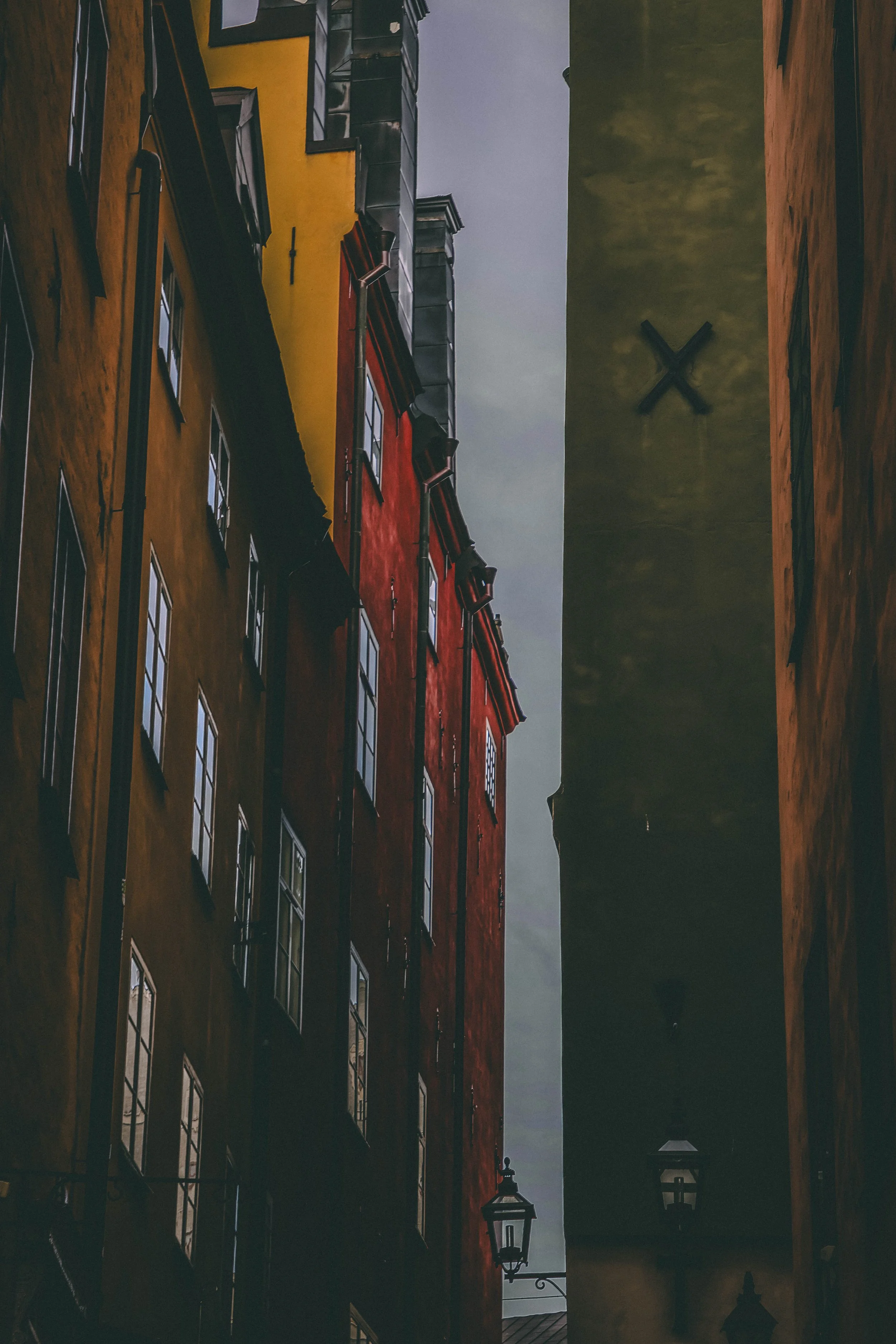 Dear reader,
If your path ever leads you to the shadowed veins of old Vinterholm, you may stumble upon a narrow alley where the buildings lean close, as if conspiring. This is no ordinary passageâit is the Alley of the Crossed Wall, a place where ti