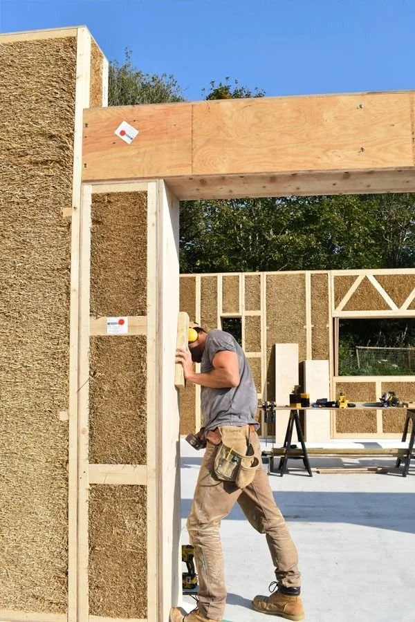 Worker framing prefabricated ecococoon strawbale panels