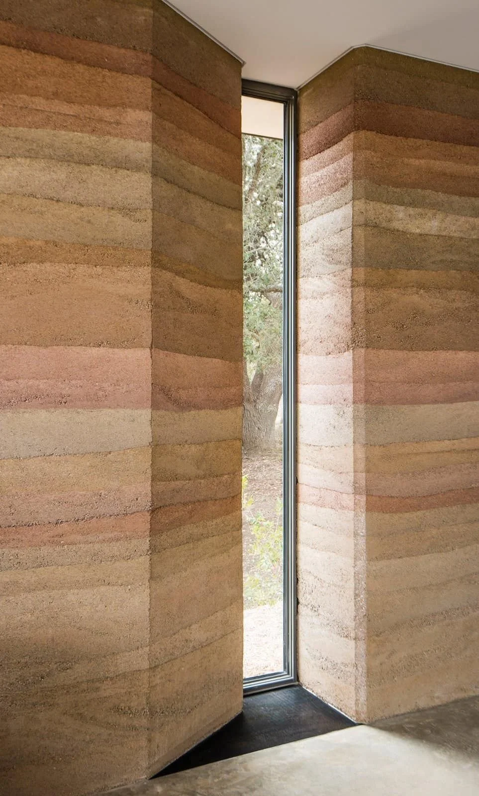 Rammed earth walls surrounding interior window