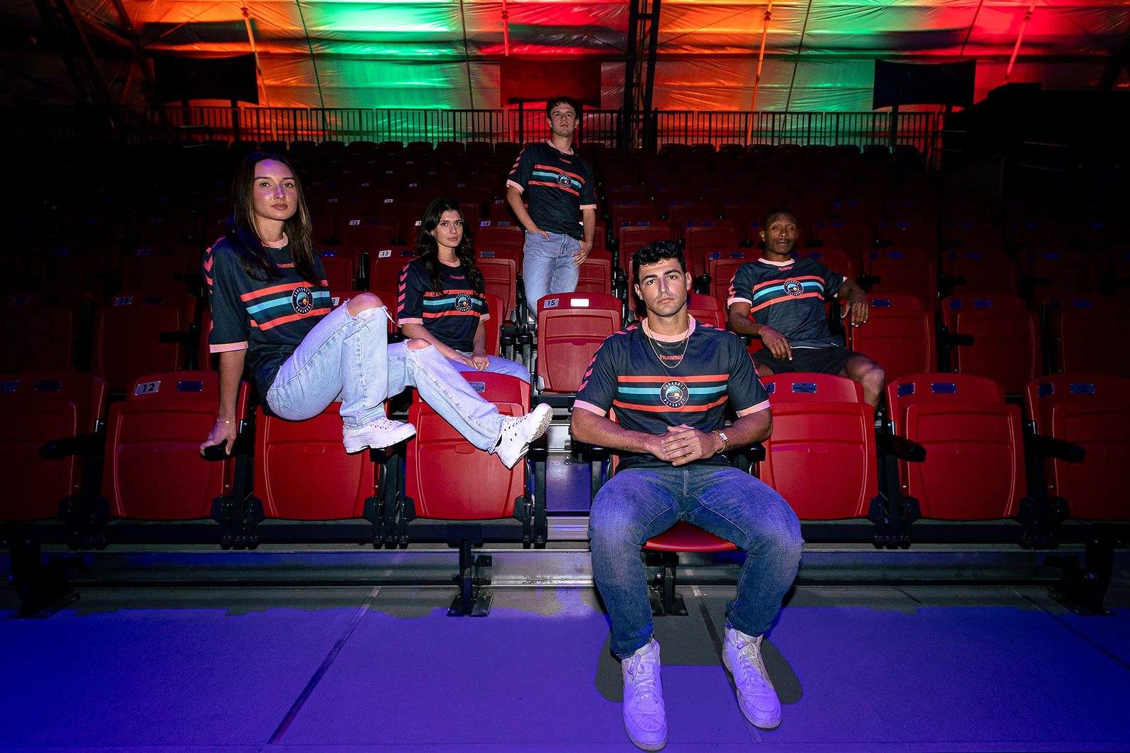 various models posing in stadium seats wearing the new Sarasota Paradise primary jersey