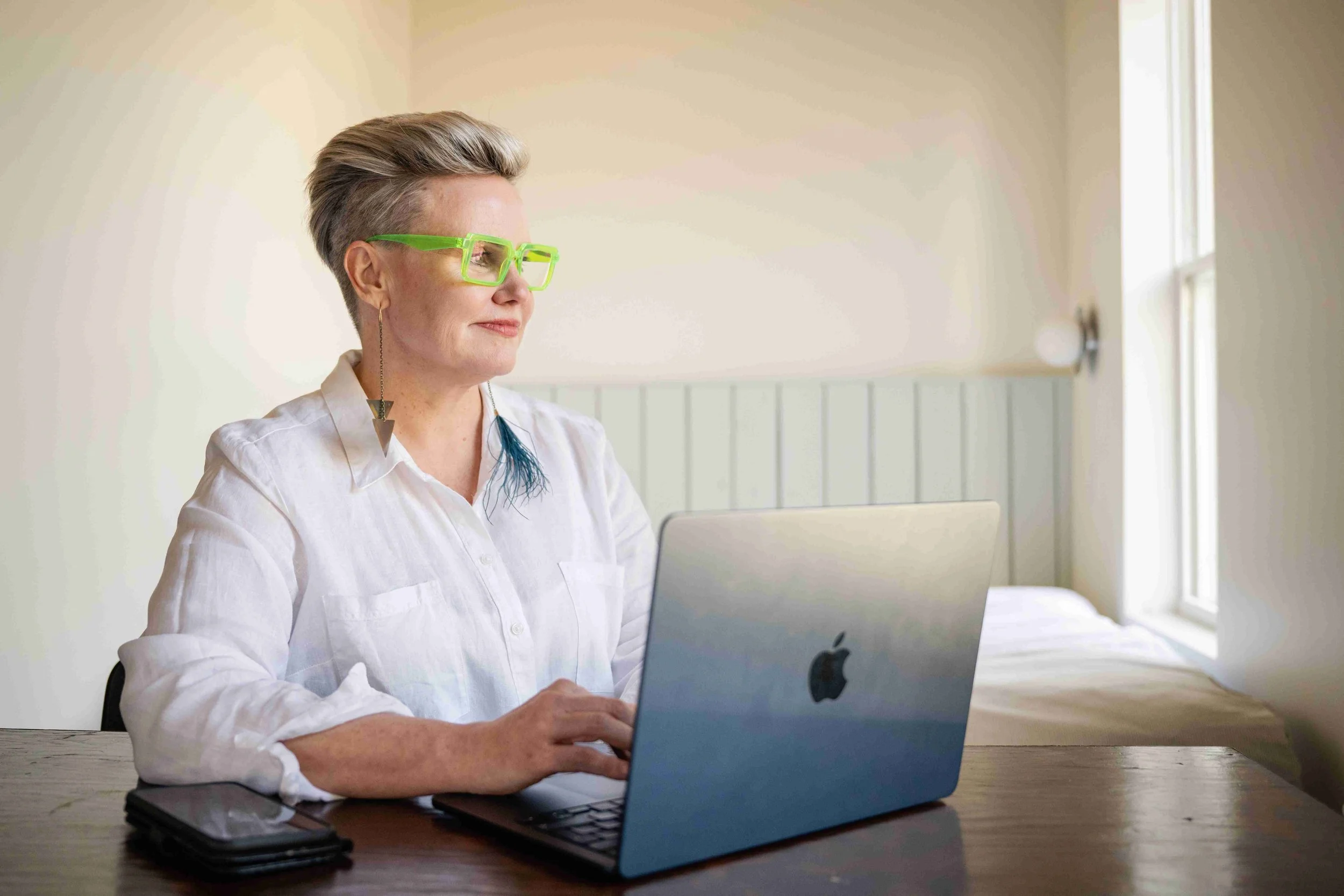 Catherine looking to the side while on laptop