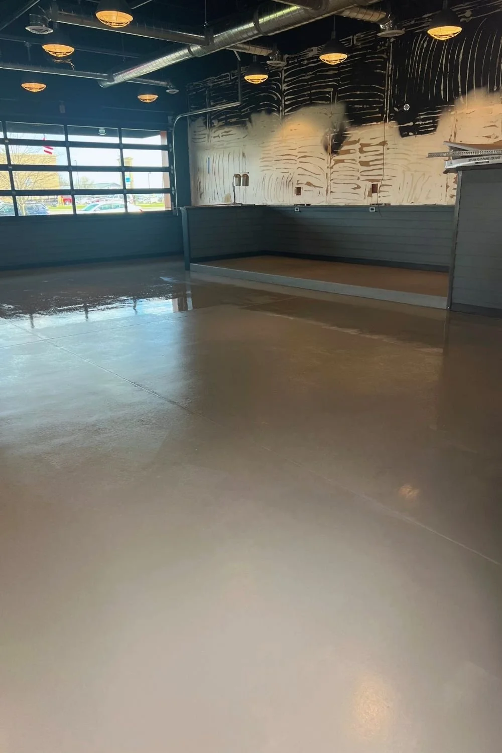 Commercial interior renovation with polished concrete floor by JECAM