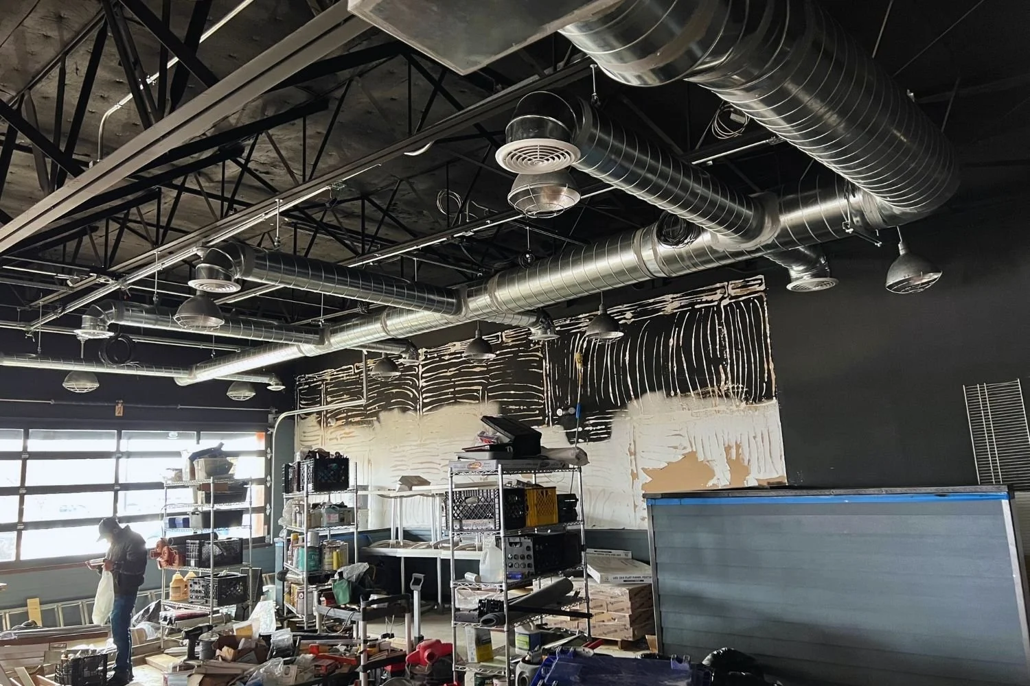 Commercial interior renovation with exposed ductwork and electrical installation by JECAM