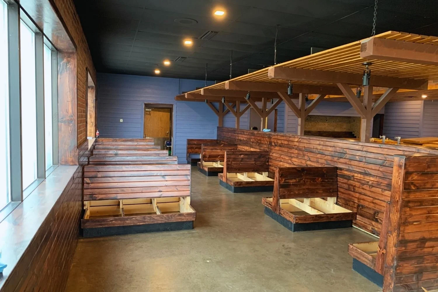 Restaurant interior under construction with custom wood booths by JECAM