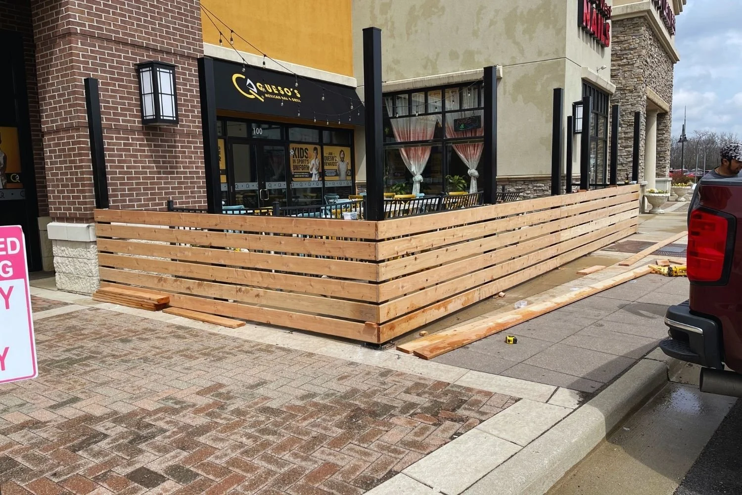 Outdoor wooden patio fence construction for commercial restaurant by JECAM