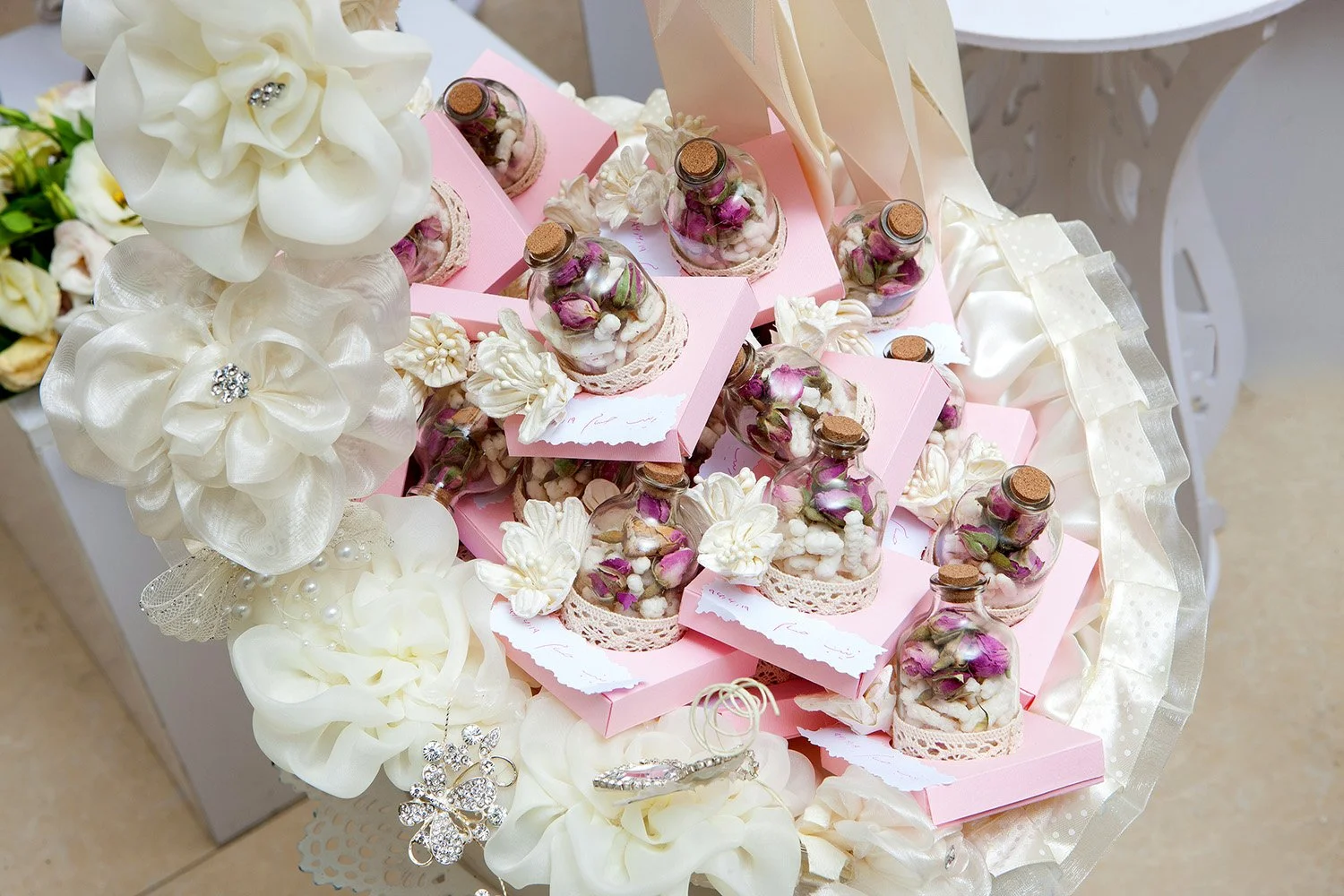 The Mediterranean-style entrance walkway to a golf club building featuring "GOLF SHOP" and "BAR & G" signs, surrounded by various palm trees in planters and a bench on the left.
