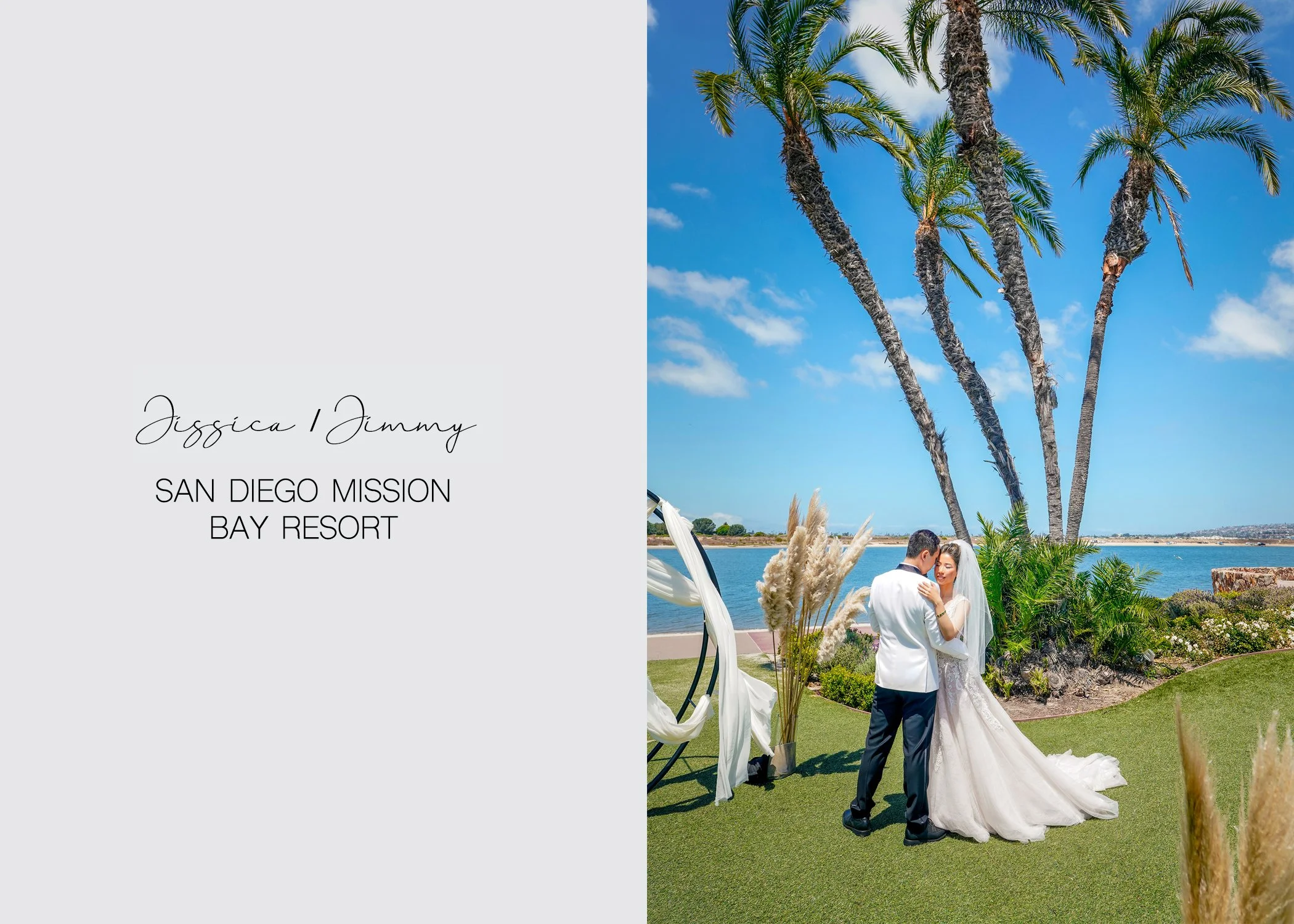 A Bride and Groom shares an embrace as they overlook a body of water lined with palm trees, capturing a romantic moment in a sunny San Diego. The scene is set on green artificial turf next to a garden area with tall grasses.