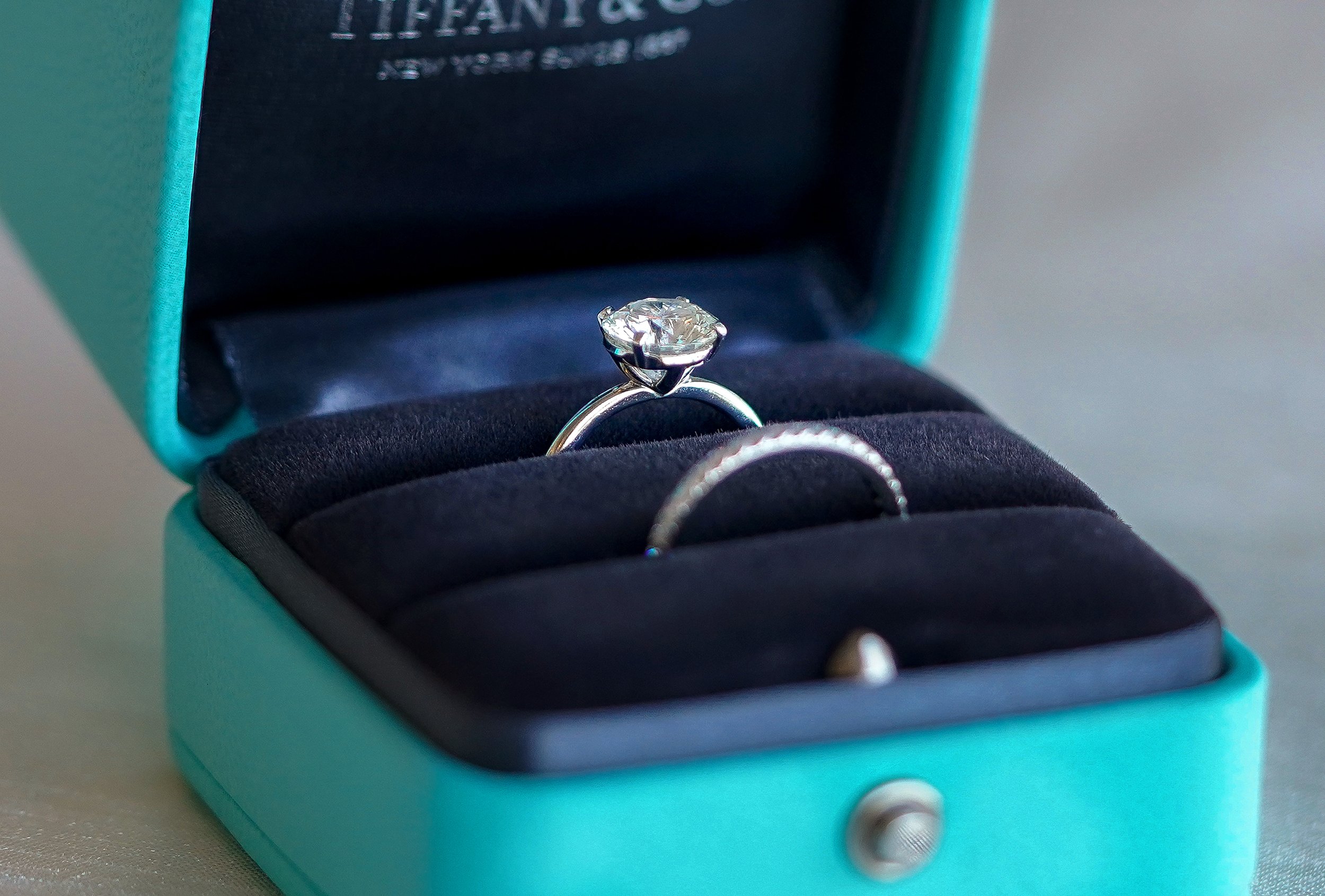 A stunning diamond engagement ring set displayed in a signature Tiffany Blue box, ready for a wedding ceremony.