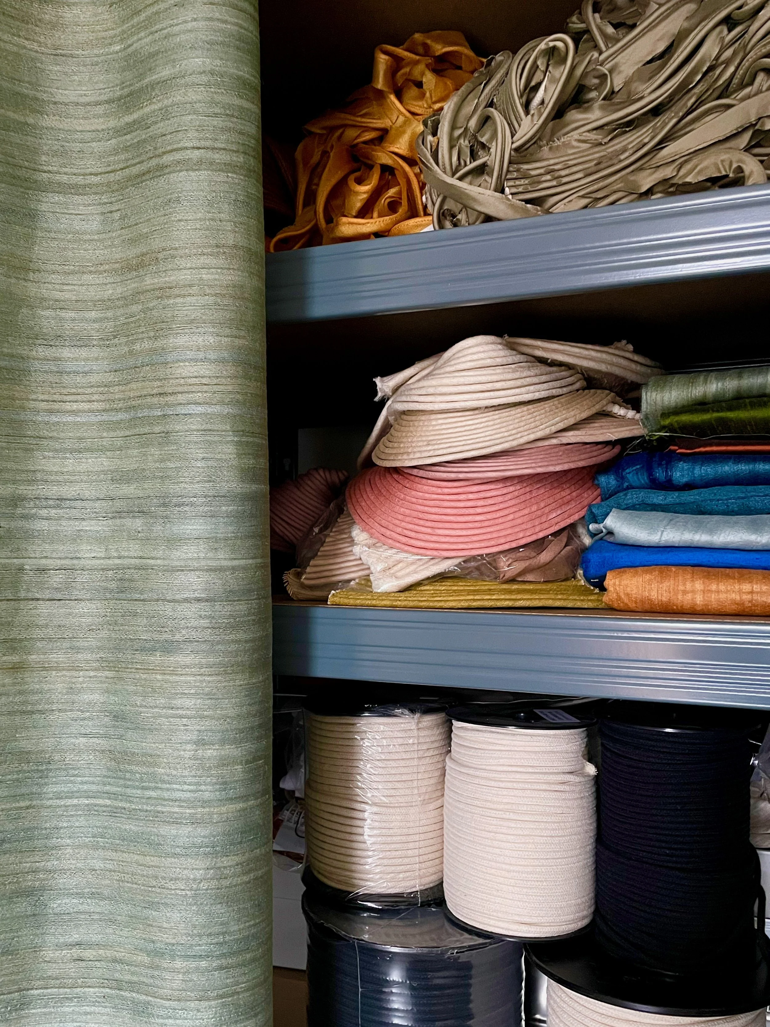 Shelves of fabric and elastic cords in various colors and sizes.