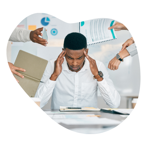 A man sitting at a desk trying to concentrate while people try giving him various things to do.