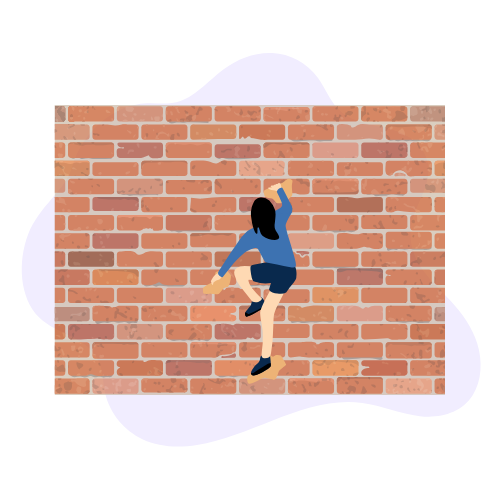A woman in a blue shirt and shorts climbing a brick wall.