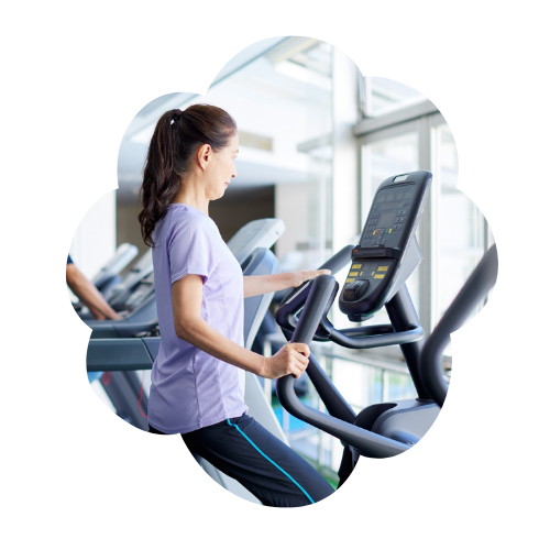 Woman using an elliptical machine at the gym as part of a daily routine.