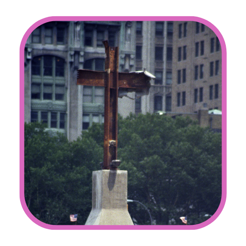 The Ground Zero Cross — a steel beam cross formation discovered in the debris — standing at the World Trade Center site.