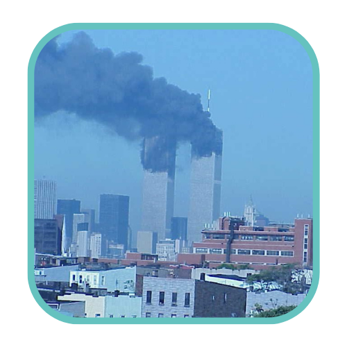 A distant view of the Twin Towers with smoke rising from both buildings on September 11, 2001.