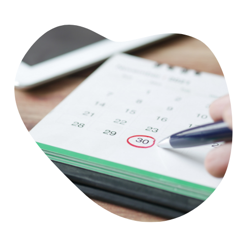 A close-up of a hand circling the 30th on a calendar with a pen, symbolizing setting deadlines to create urgency and improve task management.