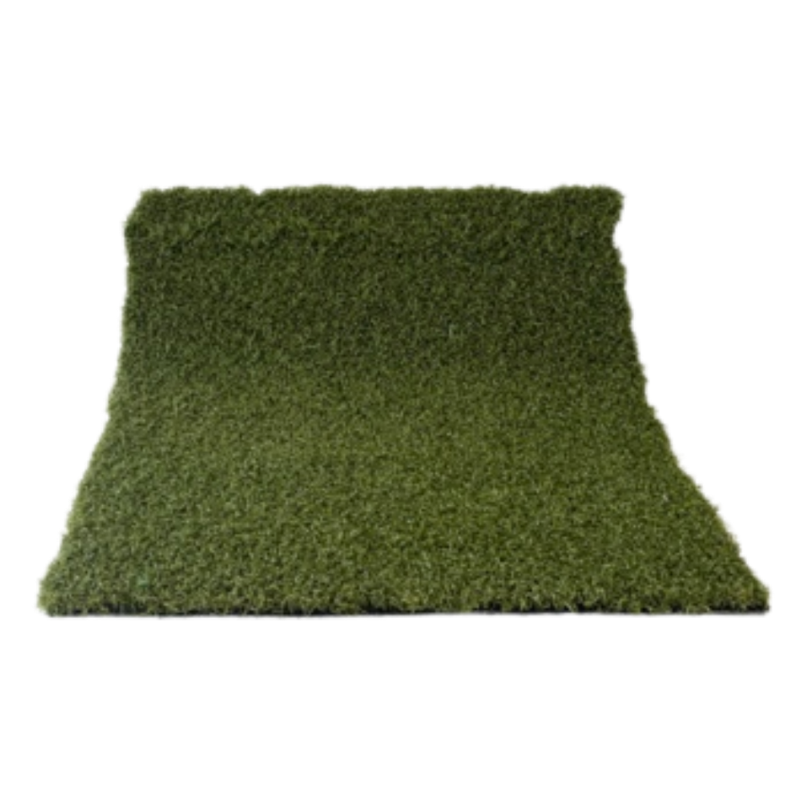 A green, trapezoid-shaped outdoor rug on a concrete surface.