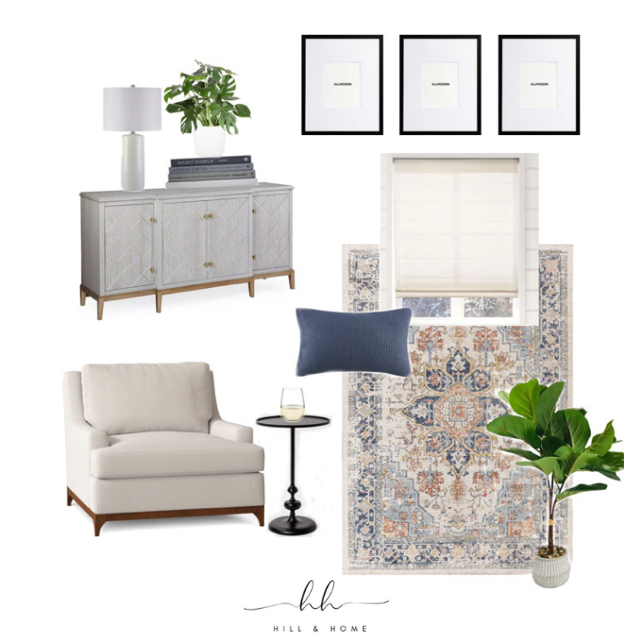 Living room corner with a white sofa, black side table with a glass of water, blue cushion, patterned area rug, window with white blind, framed artwork on the wall, white sideboard with a lamp, books, and a green plant.