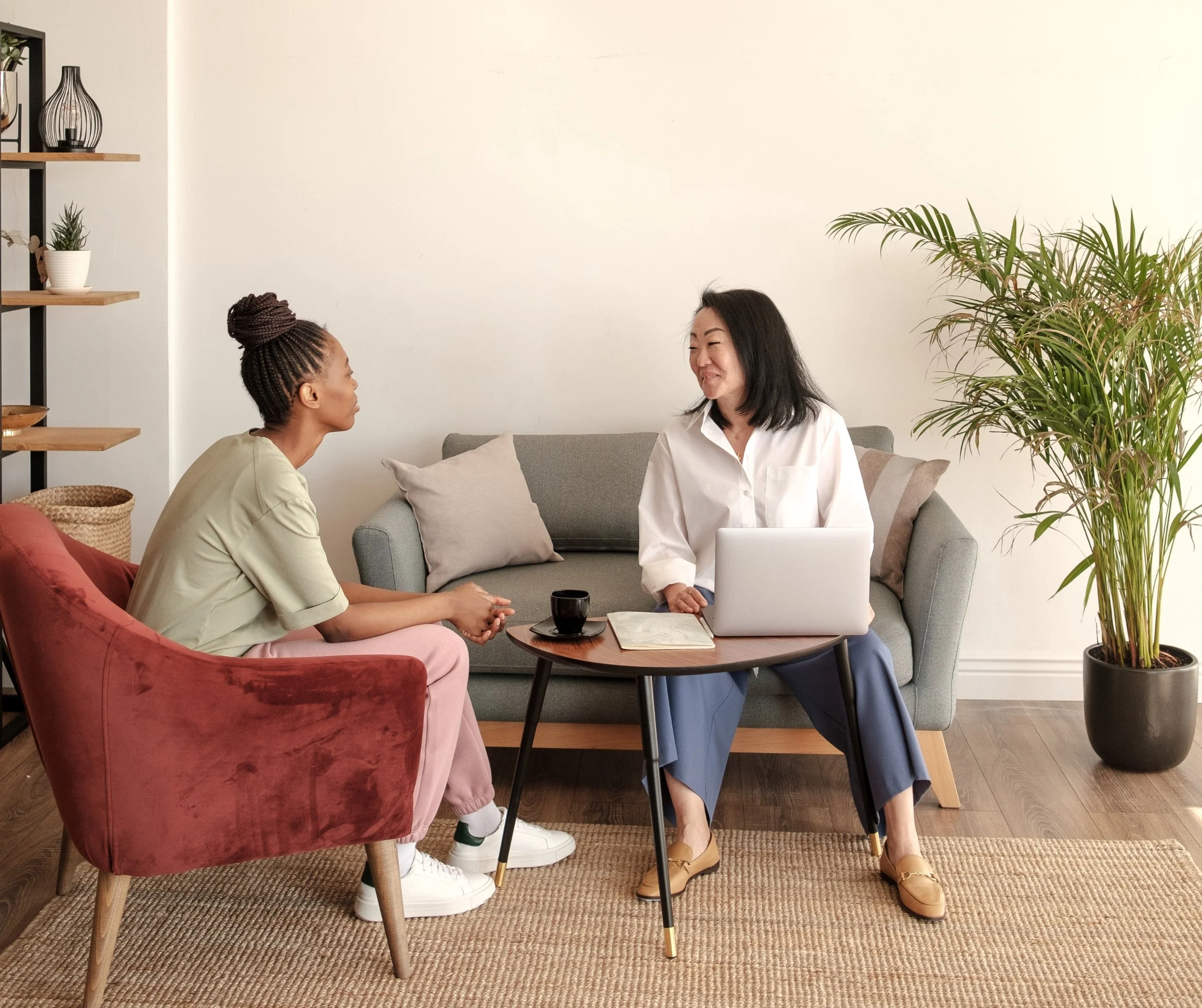 Therapist and client sitting together in a calm counselling space during a supportive mental health therapy session at a wellness clinic in East St. Paul.