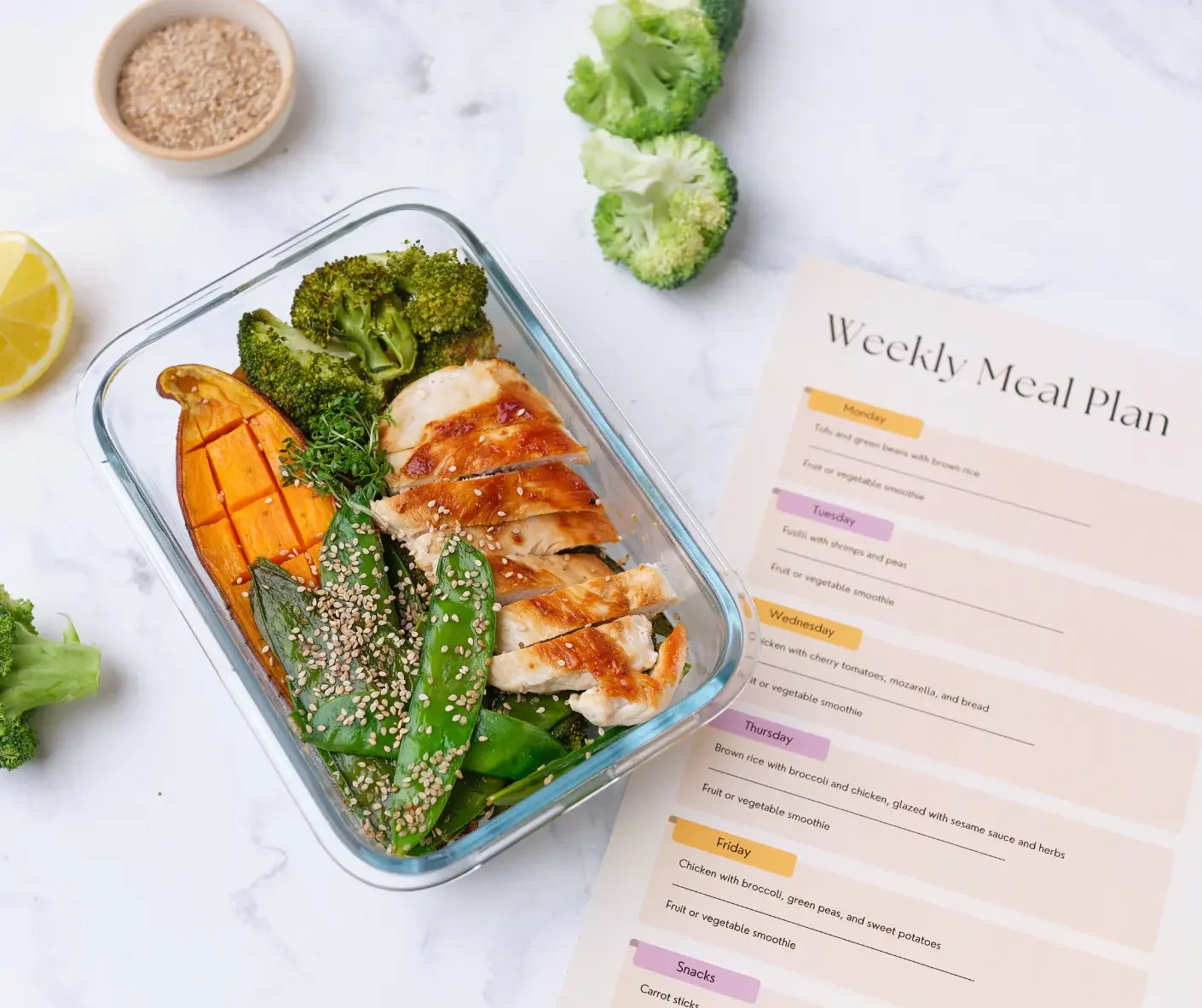 Healthy meal prep with grilled chicken, vegetables, and a weekly meal plan, representing personalized nutrition counselling and healthy eating.
