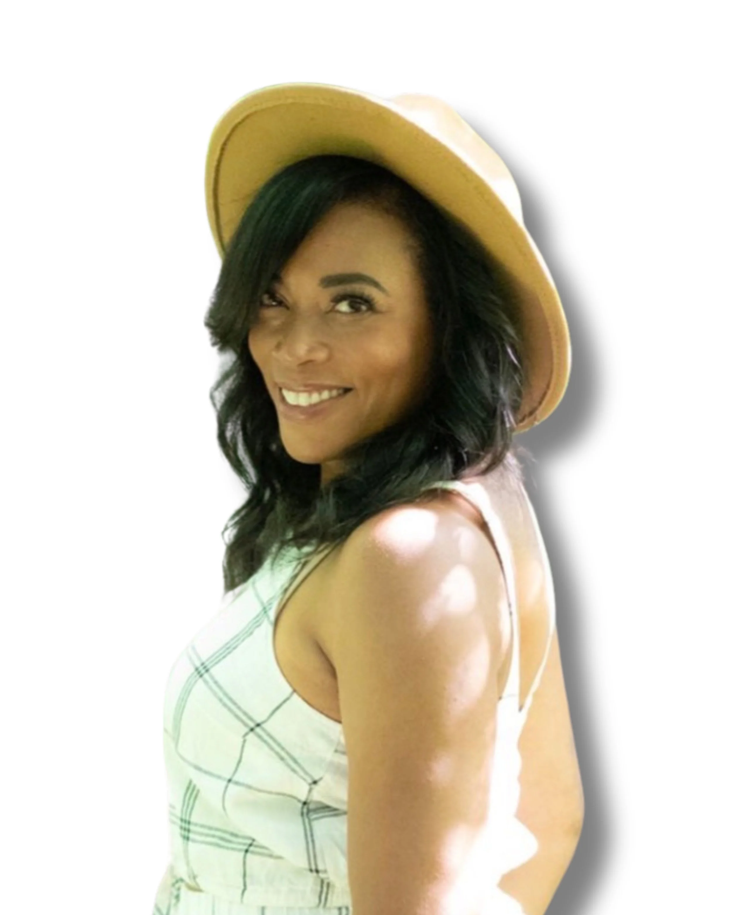Ashley Carruthers smiling in a light summer dress and tan hat, photographed outdoors with soft lighting and white background.