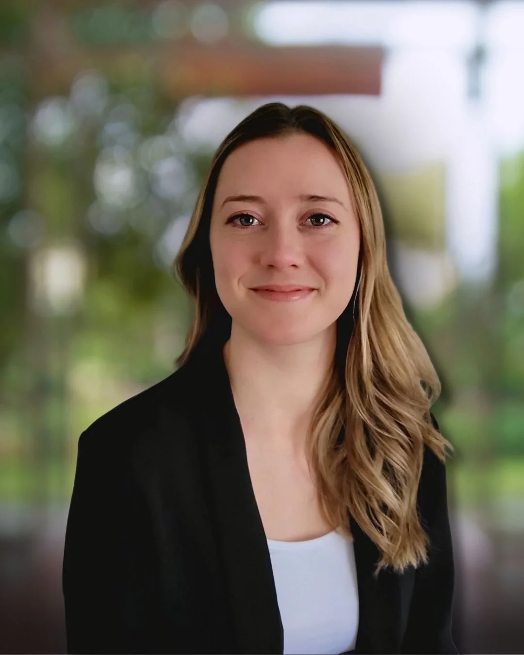 Professional headshot of Dr. Hayley Warren, ND, wearing a black blazer and white top, smiling at the camera.