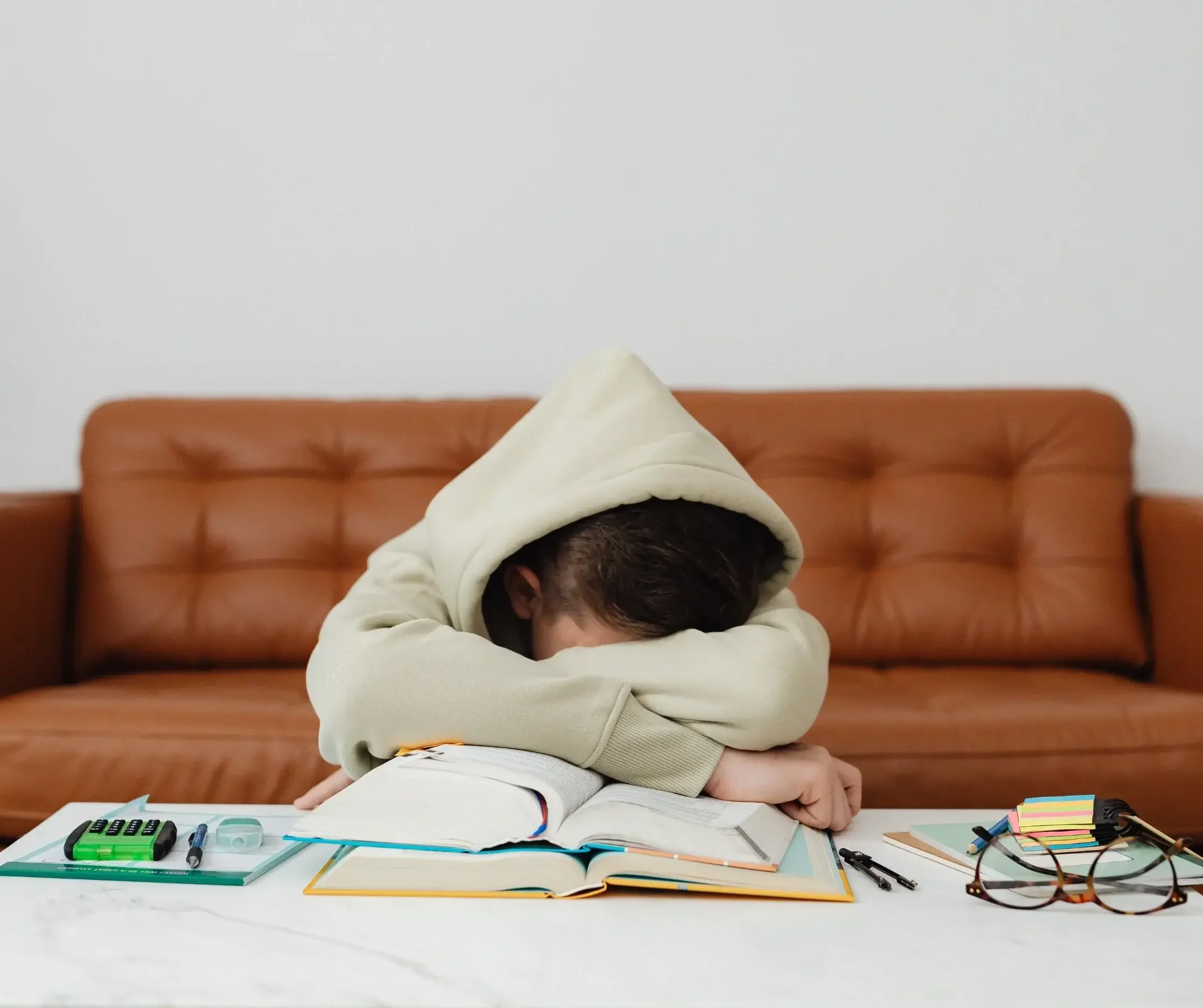 Person experiencing chronic illness fatigue and brain fog while studying