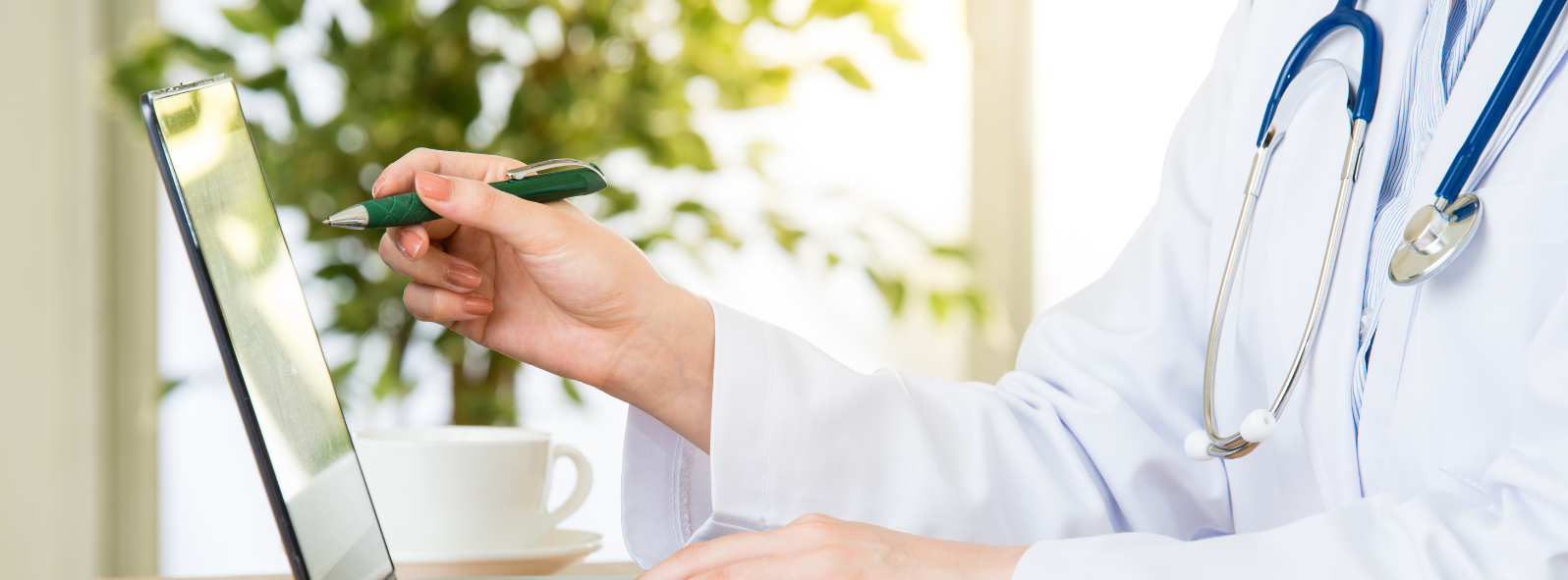 Nurse practitioner reviewing patient information during a medical consultation at an integrative healthcare clinic in Manitoba.