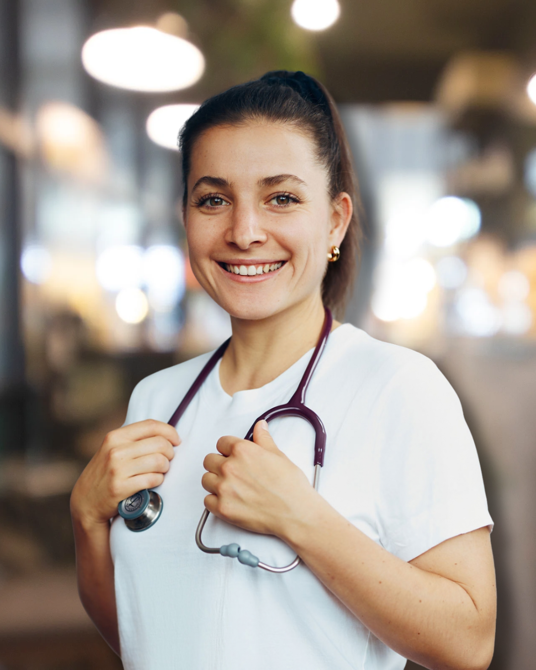 Dr. Camilia Desttefano, ND in a white shirt holding a stethescope.