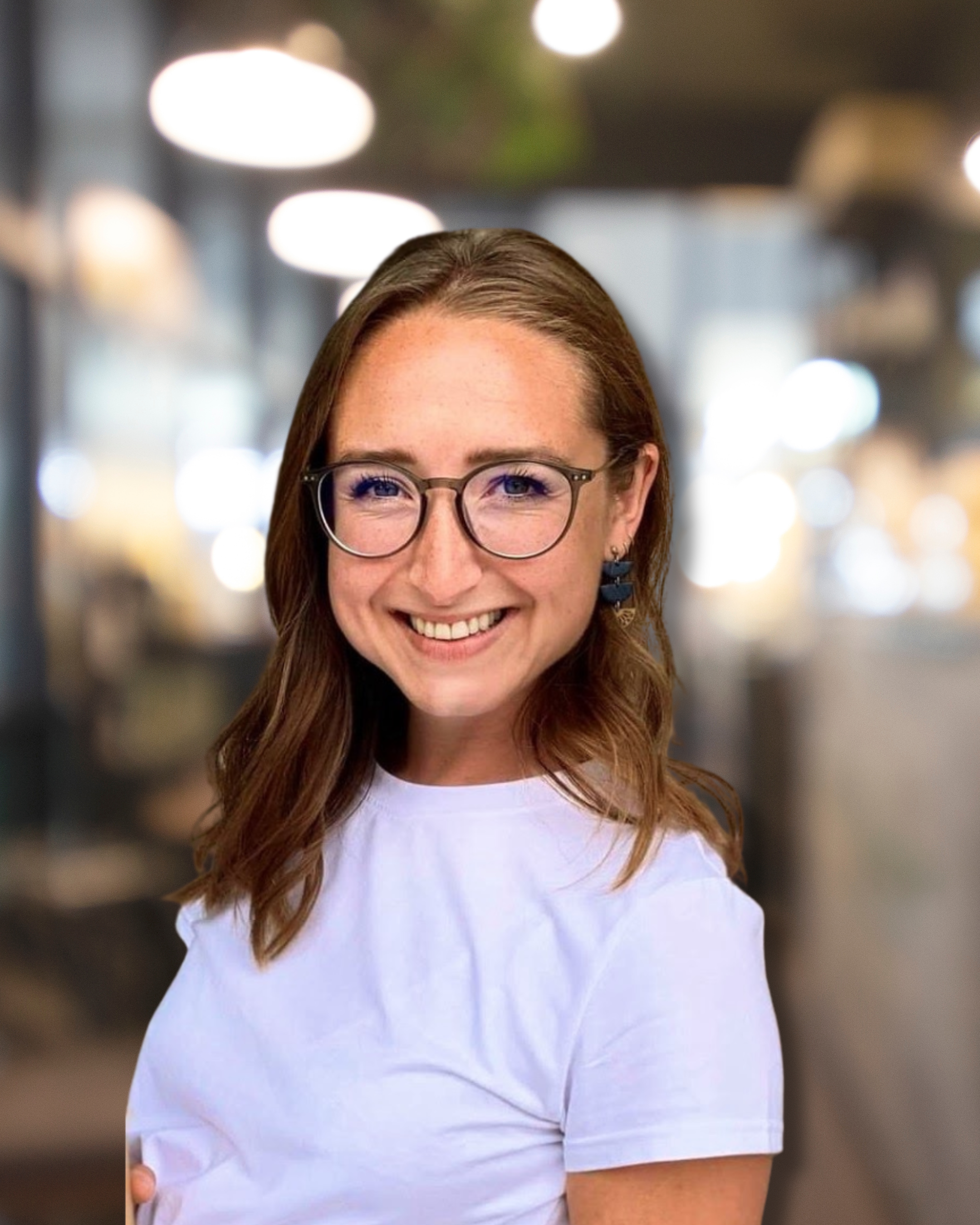 Ally Forrest, Occupational Therapist, smiling in a professional headshot with a softly blurred indoor background.