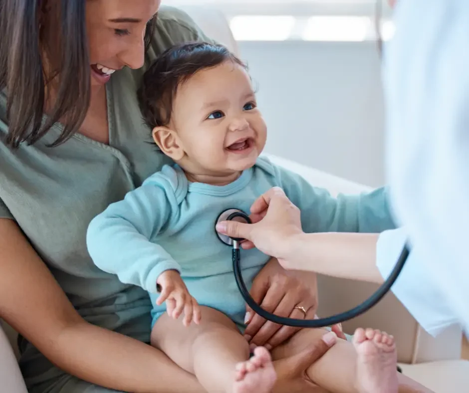 nfant receiving a wellness check with a healthcare provider during a pediatric appointment.