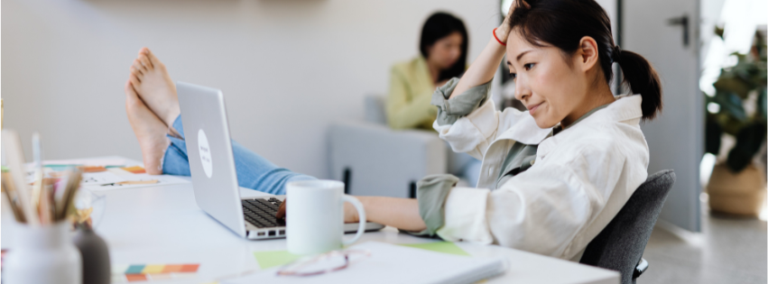 Woman feeling overwhelmed while working from home, representing chronic fatigue, stress, burnout, and ongoing health concerns treated at True Health Integrative Clinic.