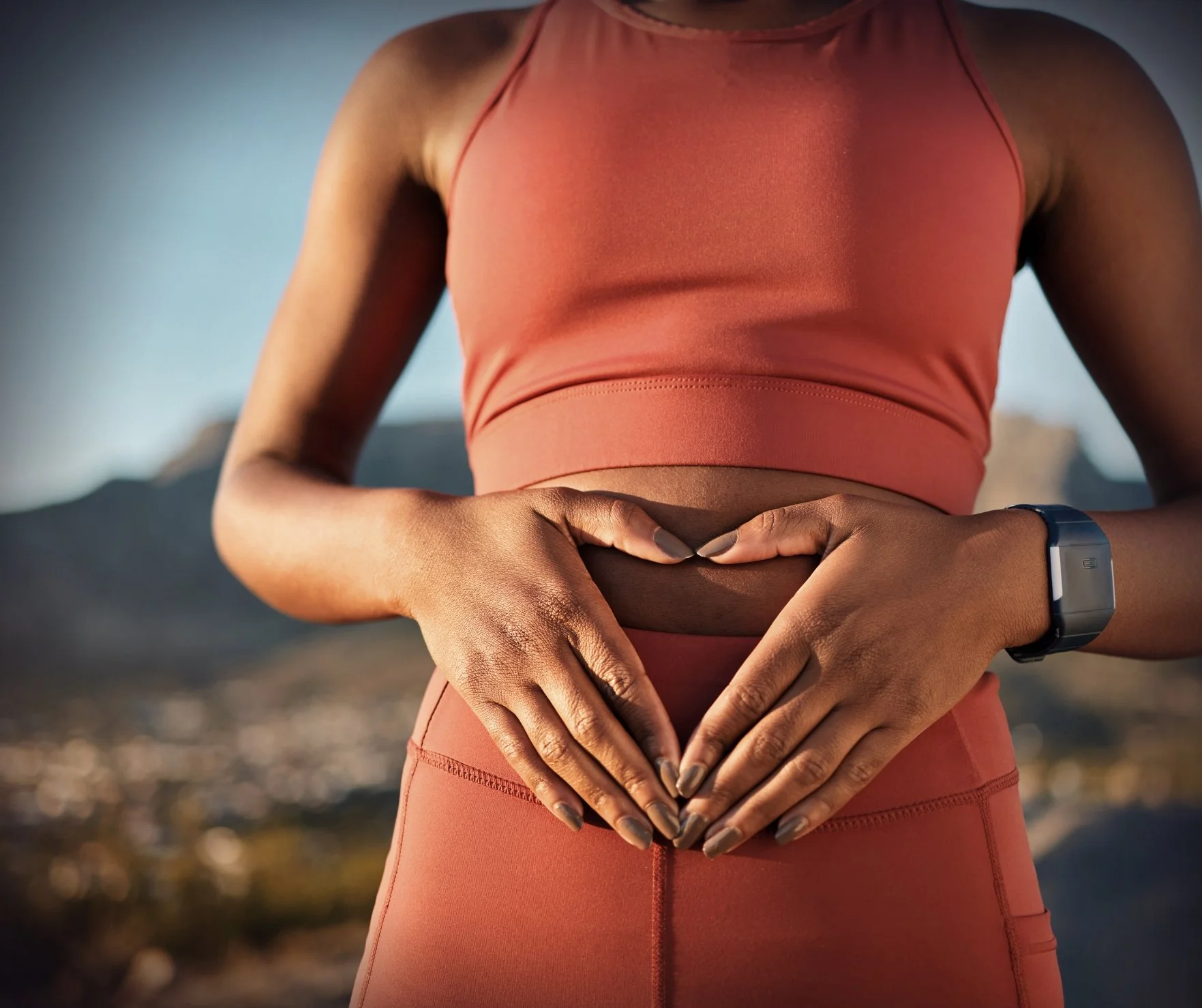 Person supporting digestive and gut health through movement, body awareness, and integrative wellness care