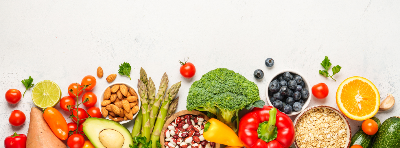Fresh whole foods including vegetables, fruit, nuts, and healthy ingredients representing nutrition, digestive health, and food sensitivity support.